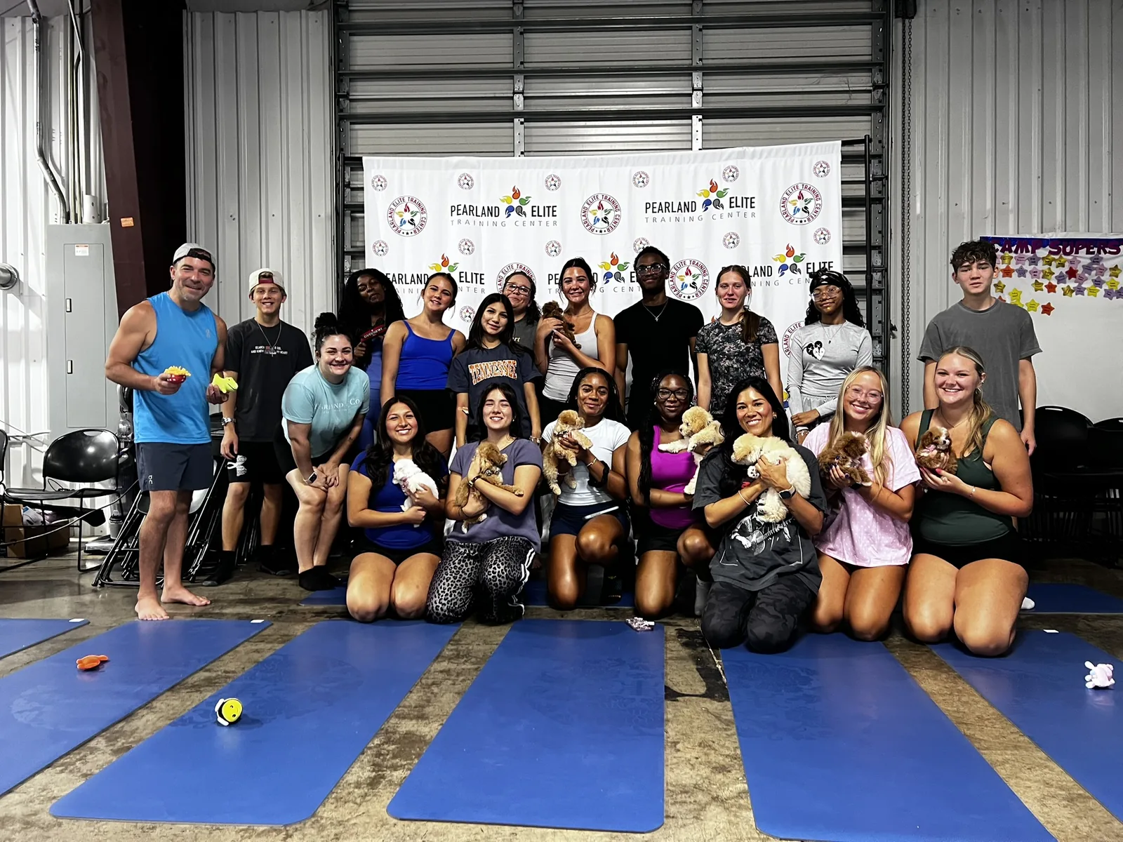 A full corporate team holding puppies at a private Pawty Yoga event in Houston