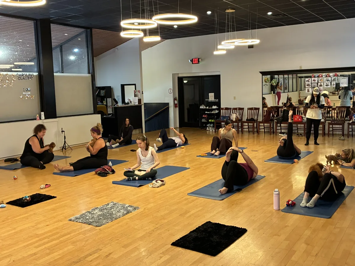 Adult group session at Pawty Yoga's Houston studio - the corporate puppy yoga format for team building and wellness events